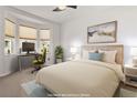 Bedroom featuring a workstation near a bay window, a bed, and neutral tones providing a calm and functional space at 13739 Legend Trl # 102, Broomfield, CO 80023