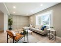 Bright living room with hardwood floors, a bay window, modern furnishings, and a decorative accent wall at 4682 Chatham St, Boulder, CO 80301