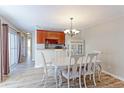 Dining area with hardwood floors, chandelier, and access to patio at 1120 Cholla Ln, Broomfield, CO 80020