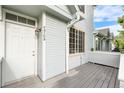 Inviting front entrance with gray siding, white trim, and a charming covered porch at 4070 E 119Th Pl # B, Thornton, CO 80233