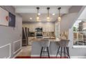 Open concept kitchen with granite countertops, stainless steel appliances, and bar seating for two at 8360 W 87Th Dr # D, Arvada, CO 80005