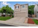Two-story home with a two-car garage, landscaped yard, and a well-manicured lawn at 1179 S Alton Ct, Denver, CO 80247