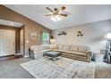Spacious living room features a large sectional sofa, decorative shelves, and a neutral rug at 1179 S Alton Ct, Denver, CO 80247