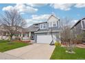 Charming two-story home with blue siding, attached two-car garage, and well-manicured front lawn at 10965 Dearborne Dr, Parker, CO 80134