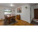 Inviting dining room featuring a wooden table, seating for six, and bright natural light at 2520 Dover Ct, Lakewood, CO 80215