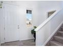 Bright entryway with light hardwood floors, white walls, a staircase, and a window allowing natural light at 16722 Chilton Dr, Mead, CO 80542