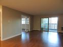 Spacious living room boasts hardwood floors and access to a bright sunroom at 9625 E Center Ave # 4C, Denver, CO 80247