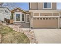 Inviting exterior featuring a well-manicured lawn and a two-car garage at 19131 E Crestridge Cir, Aurora, CO 80015