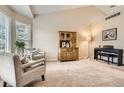 Bright living room featuring vaulted ceilings, neutral colors, and plush carpeting at 19131 E Crestridge Cir, Aurora, CO 80015