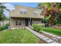 Modern two-story home with a brick facade, landscaped yard, and a unique walkway at 2935 S Sherman St, Englewood, CO 80113