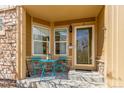 Inviting front porch with outdoor seating, a decorative rug, and charming decor near the front door at 5722 S Addison Way # A, Aurora, CO 80016