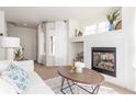 Bright living room with a cozy fireplace, neutral tones and modern decor at 5722 S Addison Way # A, Aurora, CO 80016