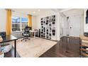 Bright and spacious home office featuring custom built-ins and a large window at 19316 W 84Th Pl, Arvada, CO 80007