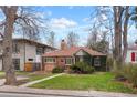 Charming brick home featuring a landscaped front yard and inviting walkway at 1665 S Saint Paul St, Denver, CO 80210