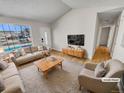 Virtually staged living room with light colored furniture and hardwood floors at 4169 S Lewiston St, Aurora, CO 80013