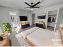 Virtually staged main bedroom with ceiling fan and walk-in closet at 4169 S Lewiston St, Aurora, CO 80013