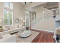 Open living room showcasing a staircase, hardwood floors, and big windows with plantation shutters at 3773 S Dayton Way, Aurora, CO 80014
