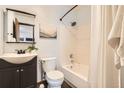 Well-maintained bathroom with a shower-tub combo, classic fixtures, and a clean, functional design at 444 Vance St, Lakewood, CO 80226