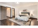 Spacious bedroom featuring a comfortable bed, patterned rug, and ample closet space for optimal storage at 444 Vance St, Lakewood, CO 80226