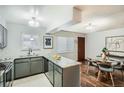 Open-concept kitchen with granite countertops and stainless steel appliances adjacent to dining area at 444 Vance St, Lakewood, CO 80226