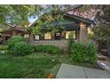 Charming brick home featuring a cozy porch and lush landscaping, perfect for enjoying the outdoors at 756 Steele St, Denver, CO 80206