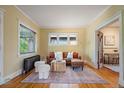 Bright living room with hardwood floors, neutral paint, a decorative rug, and access to the office at 756 Steele St, Denver, CO 80206
