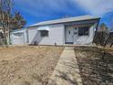 Charming single-story home featuring white siding, awning, and a well-maintained front yard at 970 Lima St, Aurora, CO 80010