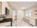 Bright kitchen with stainless steel appliances and stylish gray floors for a modern look at 970 Lima St, Aurora, CO 80010