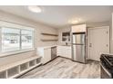 Bright kitchen featuring stainless steel appliances, white cabinetry, and stylish flooring at 970 Lima St, Aurora, CO 80010