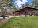 Spacious backyard with a hot tub, patio area, and beautiful landscaping perfect for outdoor living at 720 N Bluff Dr, Franktown, CO 80116