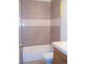 Bathroom featuring a tiled shower and tub combo, with neutral colors and functional fixtures at 10742 E Exposition Ave # 124, Aurora, CO 80012