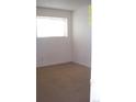Bright, carpeted bedroom with a window providing ample natural light for a calm atmosphere at 10742 E Exposition Ave # 124, Aurora, CO 80012