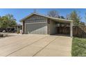 Two-car garage and connected carport, offering parking and exterior storage space at 6953 W Roxbury Pl, Littleton, CO 80128