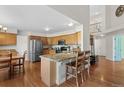 Open kitchen featuring wooden cabinets, stainless steel appliances, granite counters and breakfast bar at 9745 Quay Loop, Westminster, CO 80021