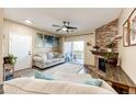 Open living area with fireplace, hardwood floors, and ample natural light at 23376 E 5Th Pl # 101, Aurora, CO 80018