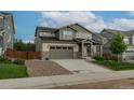Beautiful two-story home with a stone-accented facade and an attached garage at 640 Avena Dr, Elizabeth, CO 80107