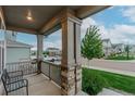 Inviting front porch with stone pillars and a cozy bench for relaxing at 640 Avena Dr, Elizabeth, CO 80107