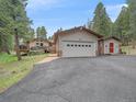 This property features an attached garage, convenient driveway, and a charming, neutral exterior at 7585 Native Dancer Trl, Evergreen, CO 80439