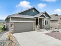 Single Gathering home with a neutral color scheme, front-facing two car garage, and a well manicured front yard at 762 Tailings Dr, Monument, CO 80132