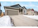 Home with a spacious driveway and a two-car garage showcasing its inviting curb appeal and modern design at 762 Tailings Dr, Monument, CO 80132