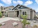 Lovely single Gathering home showing landscaped front yard and stone veneer accents on garage and entryway columns at 762 Tailings Dr, Monument, CO 80132