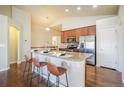 Open-concept kitchen featuring granite countertops, stainless steel appliances, and a breakfast bar with seating at 762 Tailings Dr, Monument, CO 80132