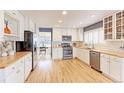 Well-lit kitchen boasts white cabinets, stainless appliances, and wood countertops at 360 Peregrine Cir, Broomfield, CO 80020