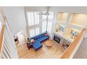 Bright living room with large windows, fireplace, and hardwood floors at 360 Peregrine Cir, Broomfield, CO 80020