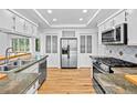 Bright kitchen with stainless appliances, granite counters, and hardwood floor at 900 Ballantine Rd, Golden, CO 80401