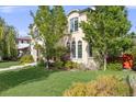 Stucco exterior with arched windows and lush landscaping at 2362 Spruce Way, Denver, CO 80238