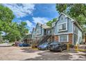 Blue townhouses with brick bases, private entrances, and parking spaces in a leafy neighborhood at 63 S Sable Blvd # E22, Aurora, CO 80012