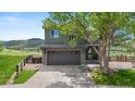 Charming two-story home with a spacious two-car garage, fenced yard, and beautiful landscaping at 9721 Marmot Ridge Cir, Littleton, CO 80125
