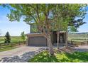 Charming two-story home with a spacious two-car garage, fenced yard, and beautiful landscaping at 9721 Marmot Ridge Cir, Littleton, CO 80125