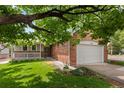 Beautiful home featuring a brick facade, well-maintained lawn, and an attached two-car garage at 1901 S Union Pl, Lakewood, CO 80228